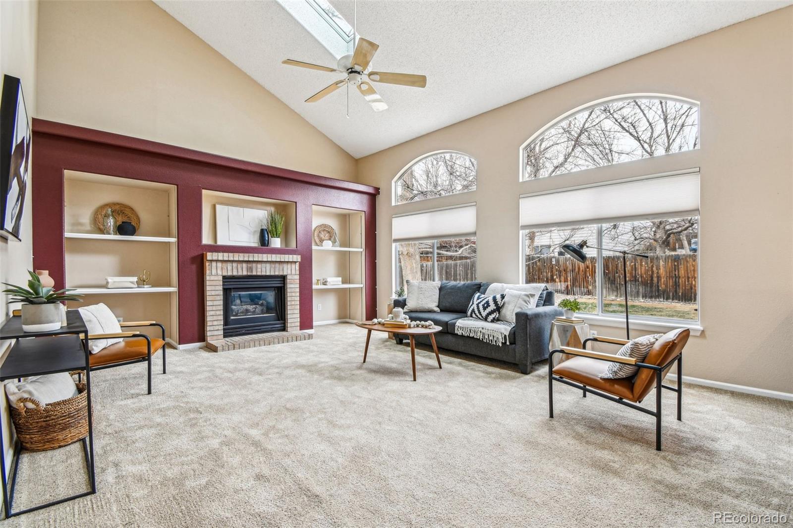 9722 Kipling Street Westminster, CO 80021 - Photo 9 of 45 a living room with furniture a fireplace and a large window