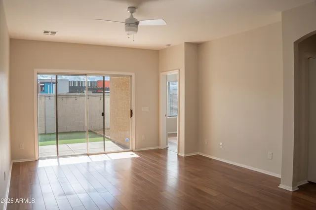 a view of an empty room with wooden floor