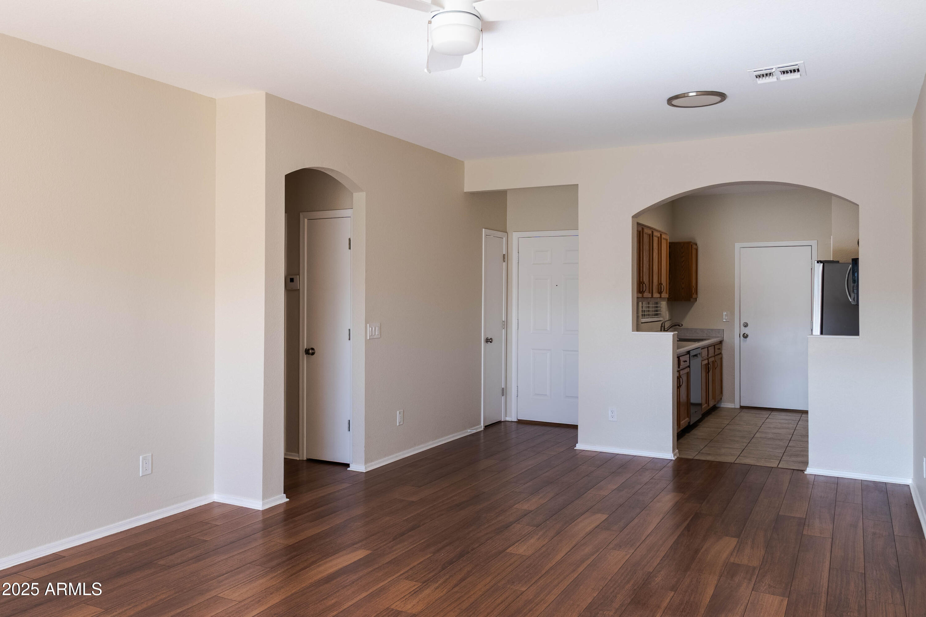 625 North Hamilton Street, Unit 27 Chandler, AZ 85225 - Photo 13 of 40 an empty room with wooden floor and a ceiling fan