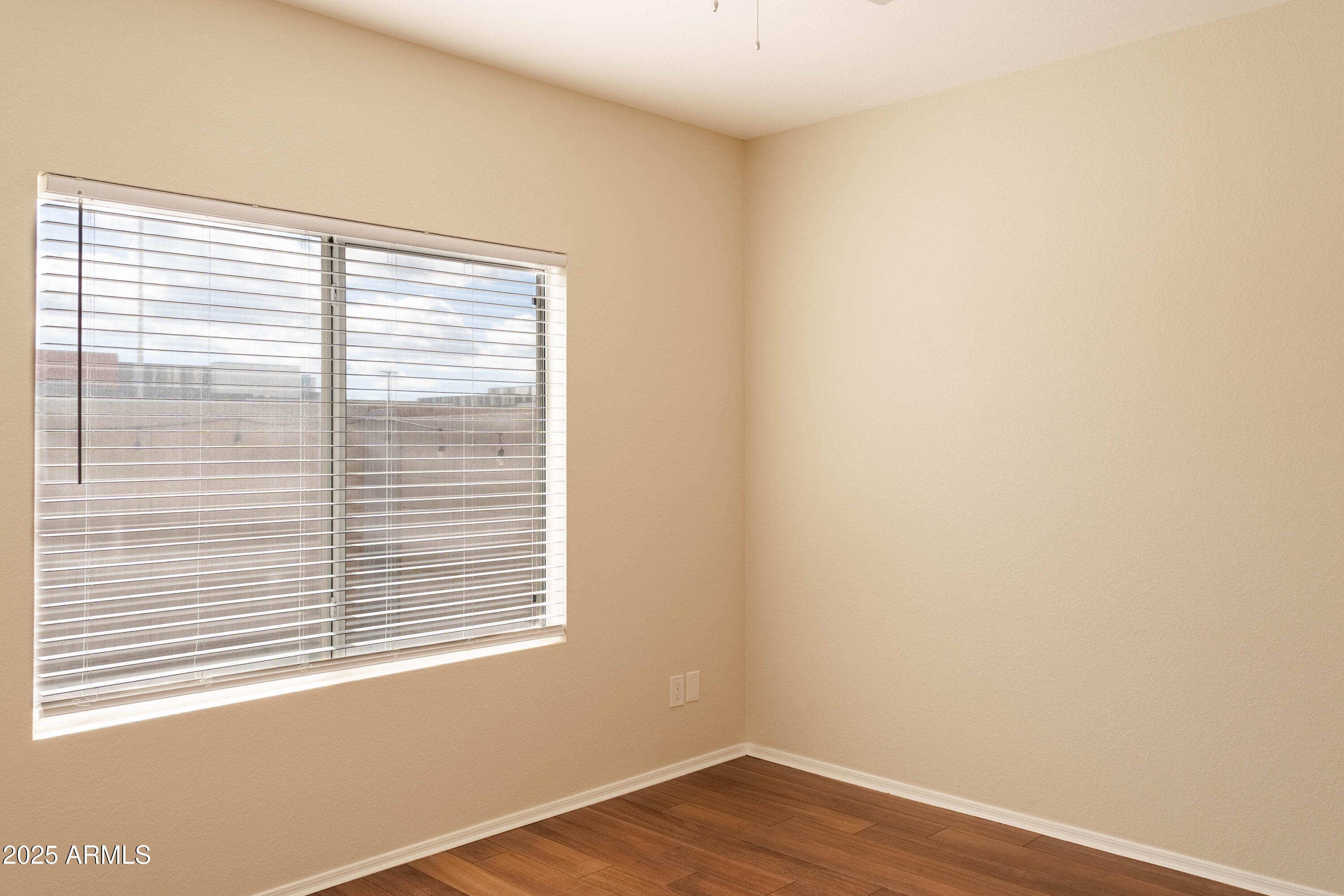 625 North Hamilton Street, Unit 27 Chandler, AZ 85225 - Photo 15 of 40 a view of an empty room with wooden floor and a window