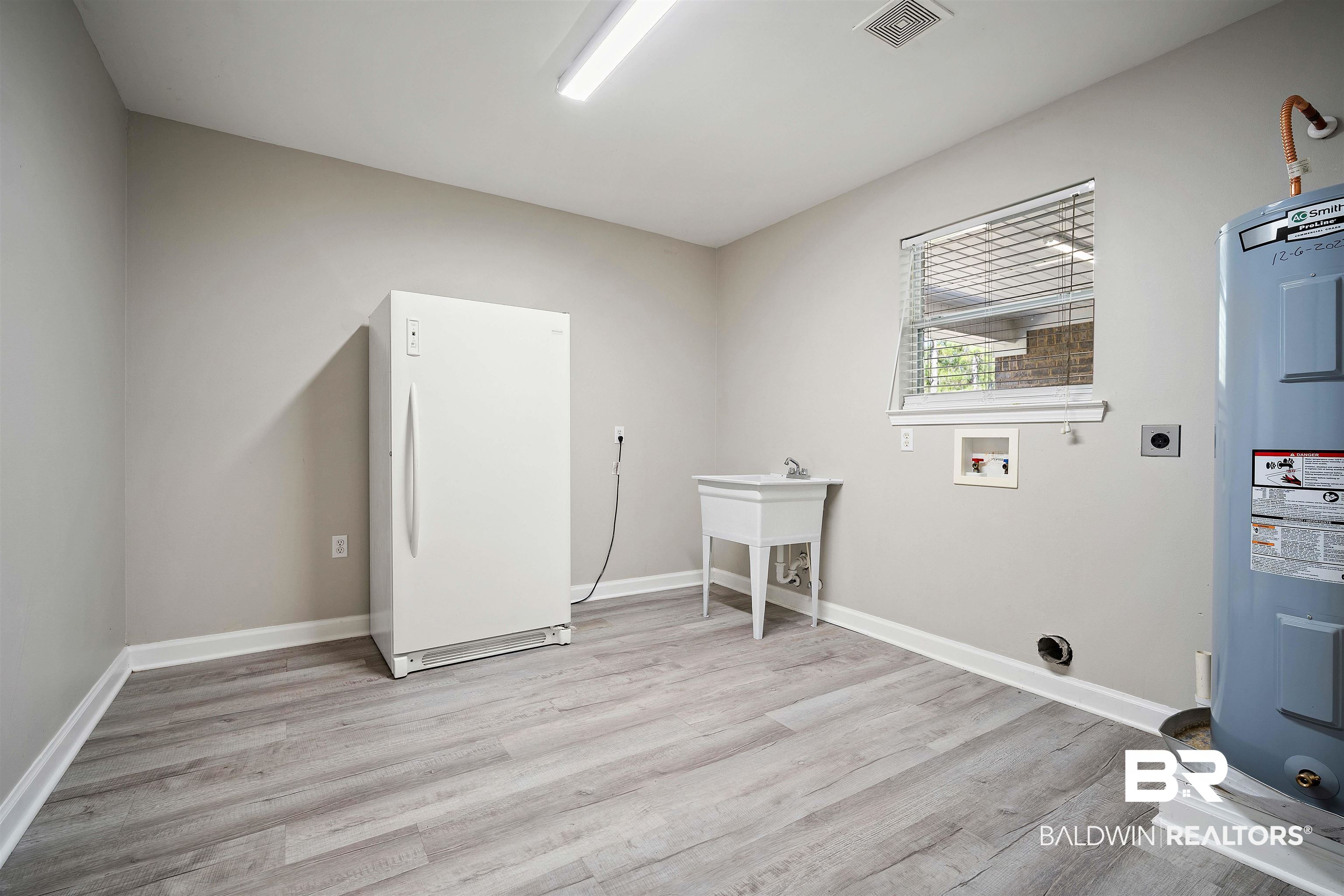 3010 Drag Strip Lane Coden, AL 36523 - Photo 28 of 44 Laundry room featuring light wood-type flooring, hookup for a washing machine, electric water heater, and hookup for an electric dryer