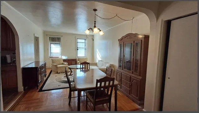 a view of a dining room with furniture and a chandelier