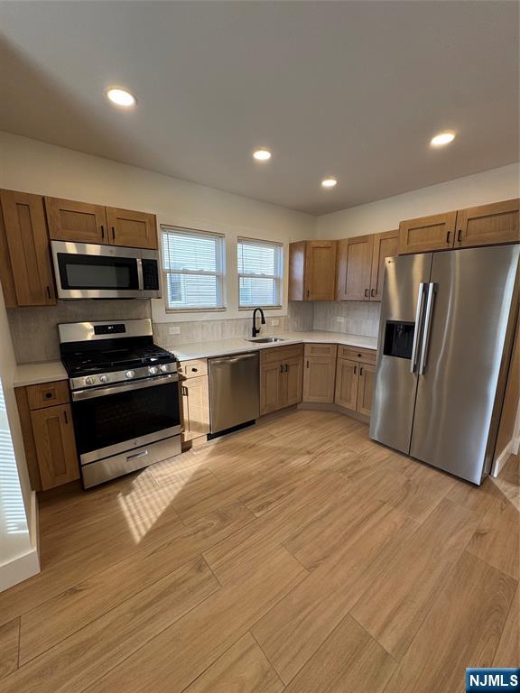 a kitchen with stainless steel appliances granite countertop a refrigerator and a stove top oven