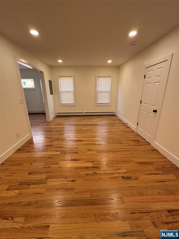 904 Kilsyth Road, Unit 1 Elizabeth, NJ 07208 - Photo 5 of 17 a view of empty room with wooden floor and fan