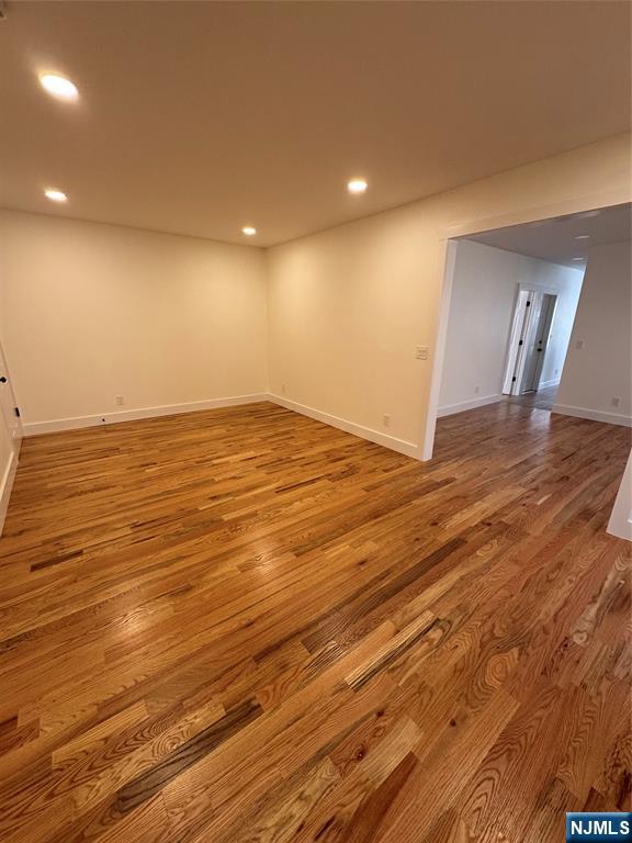904 Kilsyth Road, Unit 1 Elizabeth, NJ 07208 - Photo 6 of 17 a view of an empty room with wooden floor and a window