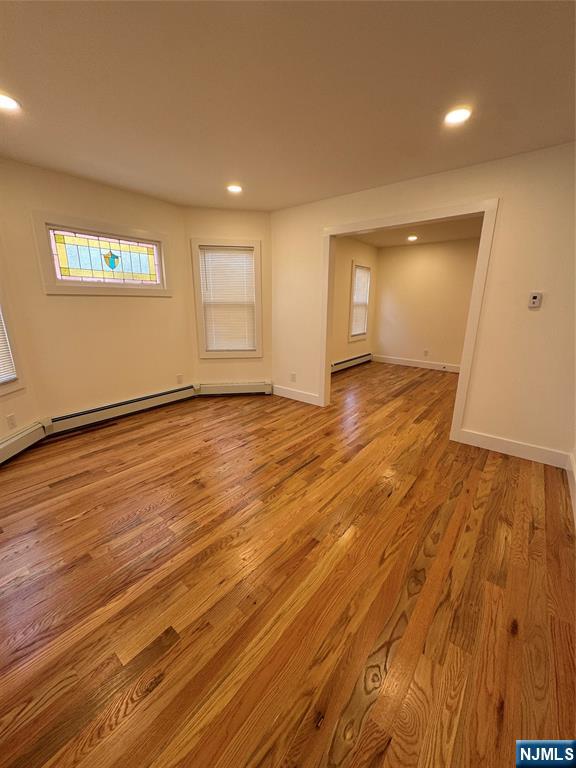 904 Kilsyth Road, Unit 1 Elizabeth, NJ 07208 - Photo 7 of 17 an empty room with wooden floor and windows