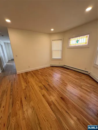 a view of an empty room and wooden floor