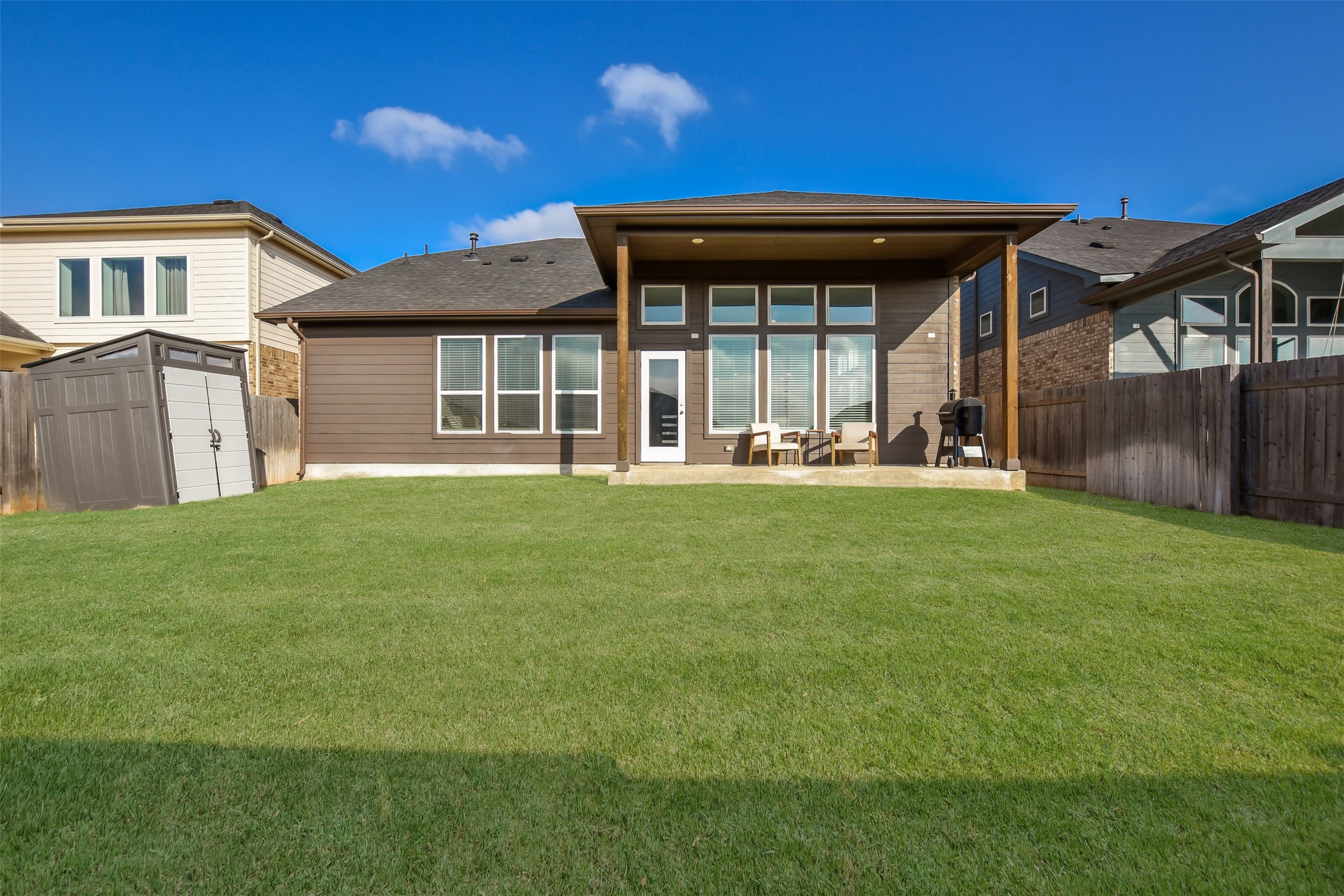 605 Oleander Loop Buda, TX 78610 - Photo 29 of 32 a backyard of a house with table and chairs