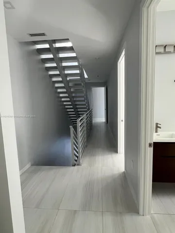 a bathroom with a double vanity sink toilet mirror and shower