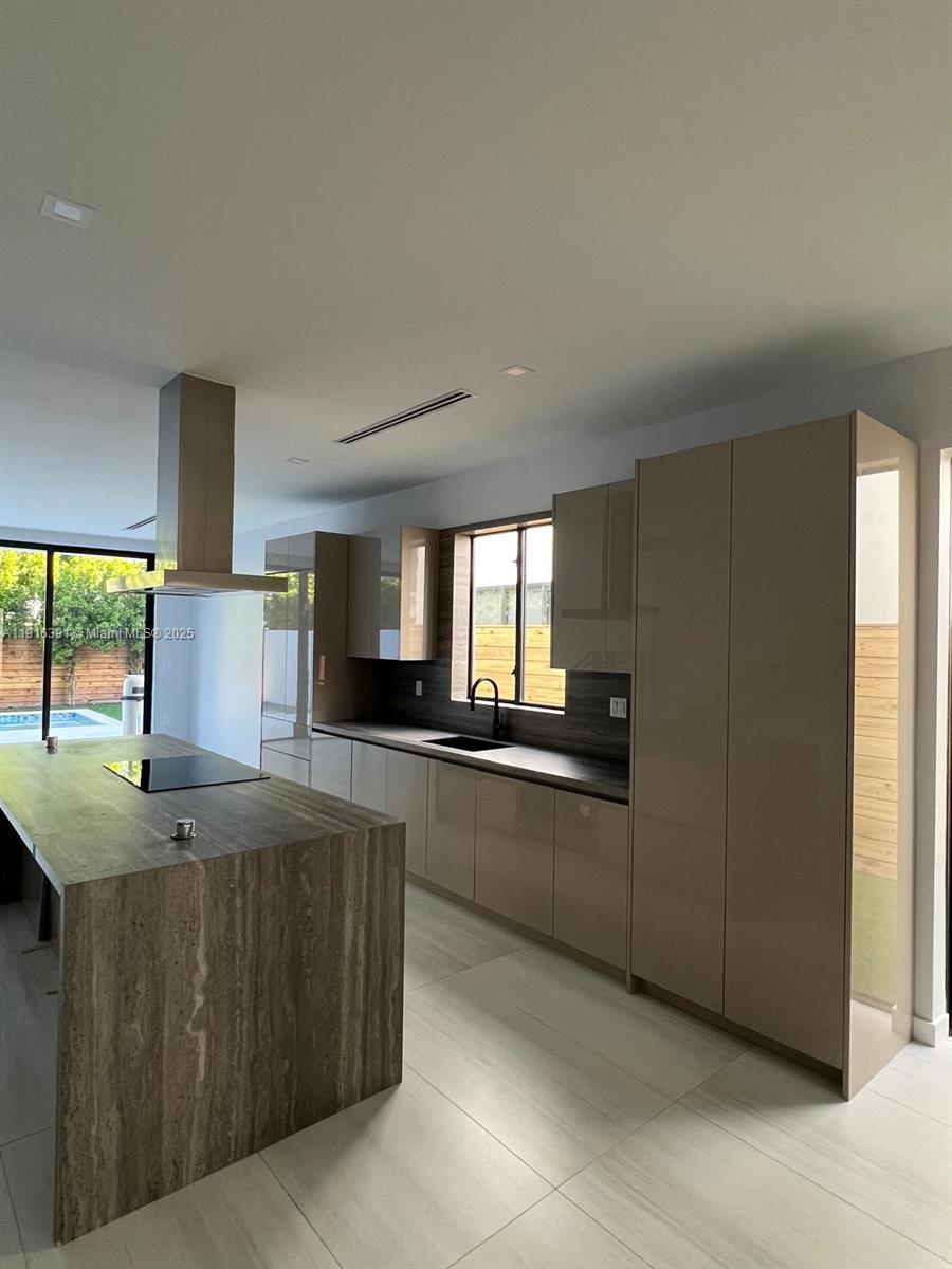 1531 Southwest 22nd Terrace Miami, FL 33145 - Photo 2 of 29 a kitchen with stainless steel appliances granite countertop a sink and a refrigerator