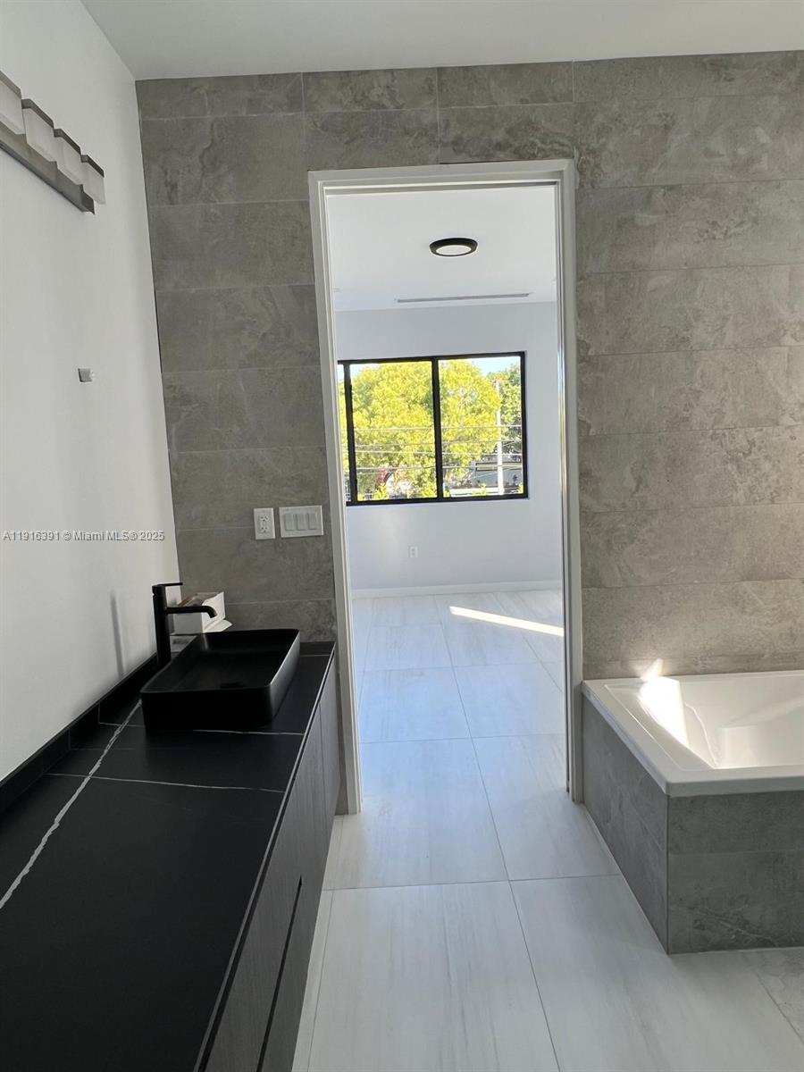 1531 Southwest 22nd Terrace Miami, FL 33145 - Photo 24 of 29 a bathroom with a granite countertop sink and vanity