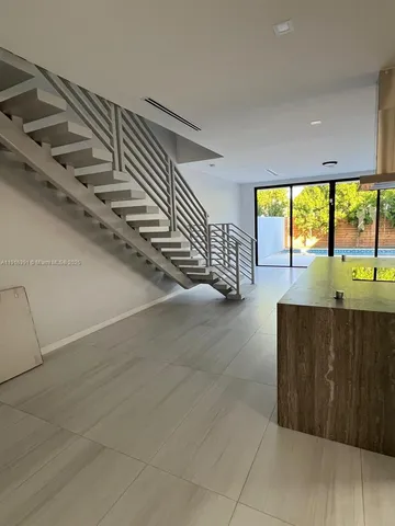a view of entryway and bedroom with wooden floor