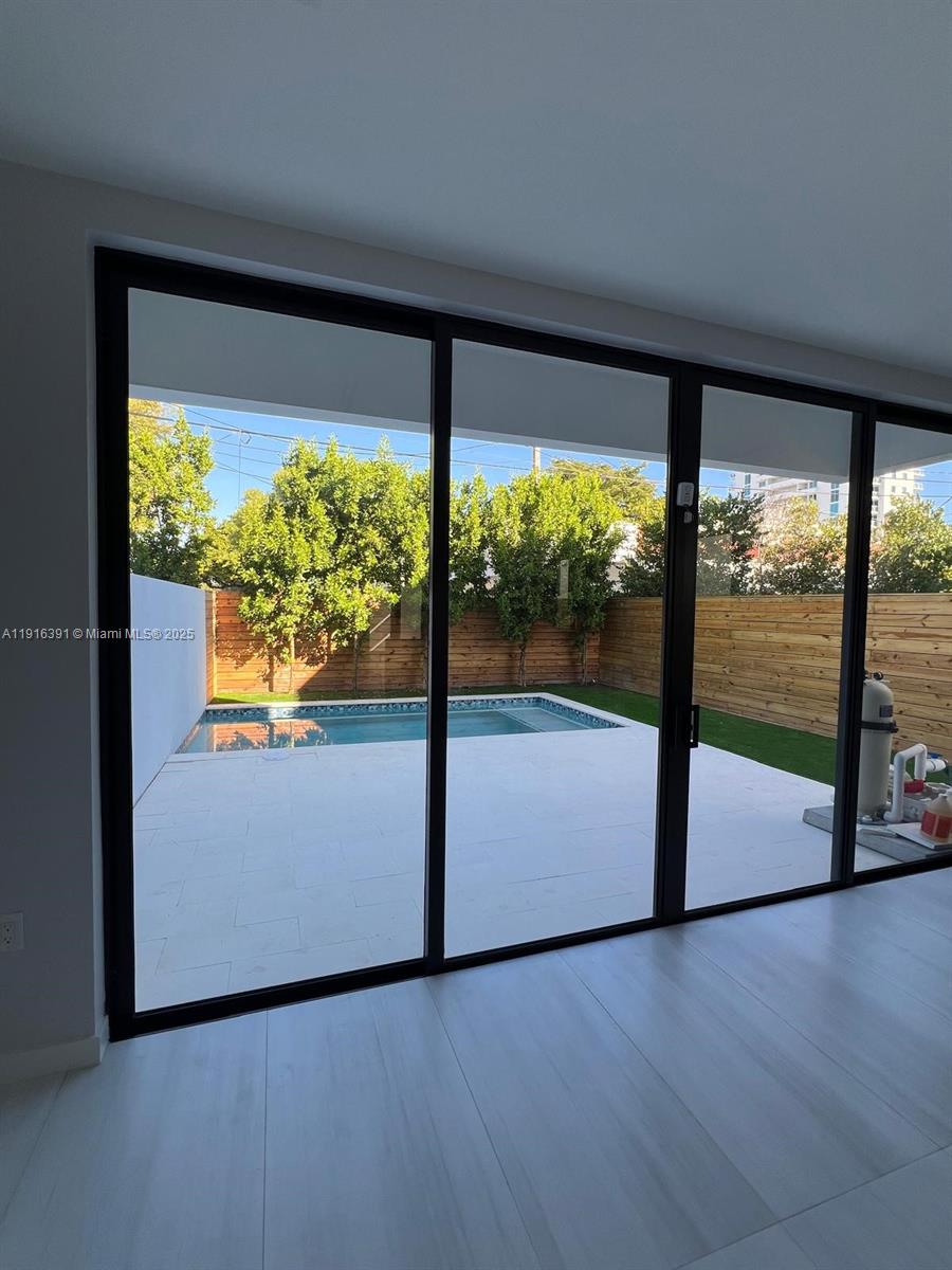 1531 Southwest 22nd Terrace Miami, FL 33145 - Photo 7 of 29 a view of an empty room with wooden floor and a floor to ceiling window
