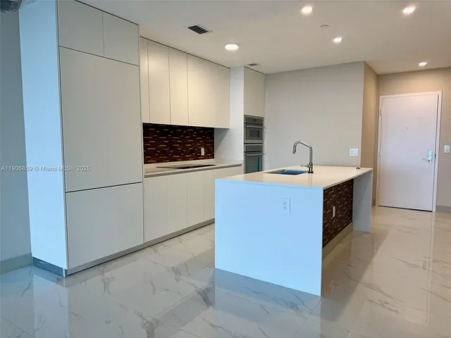 a spacious bathroom with a sink a mirror and a shower