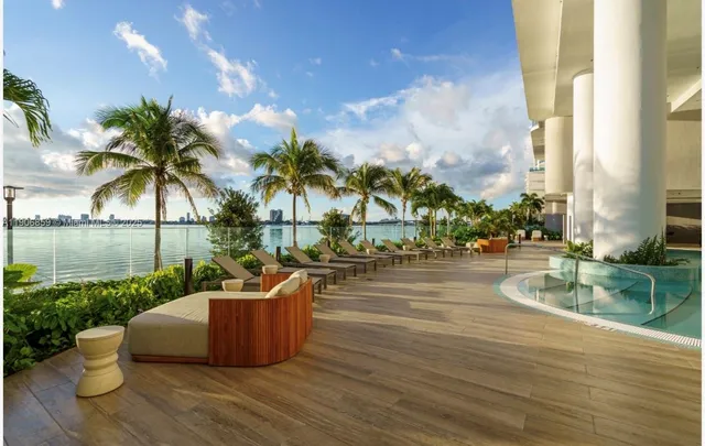 a view of a lake with a fountain and a big yard