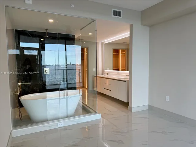 a view of a kitchen with a tub and windows