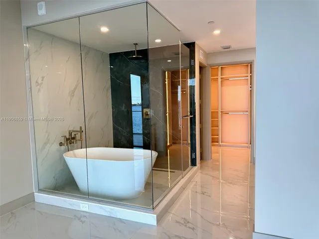 a bathroom with a bathtub and shower