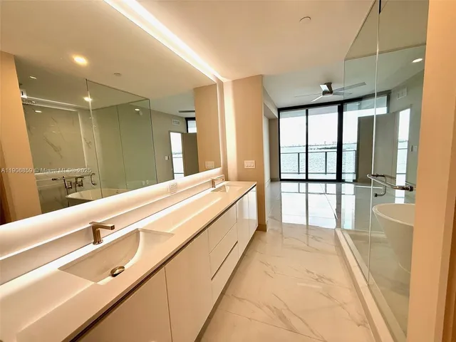 a spacious bathroom with a large tub and shower