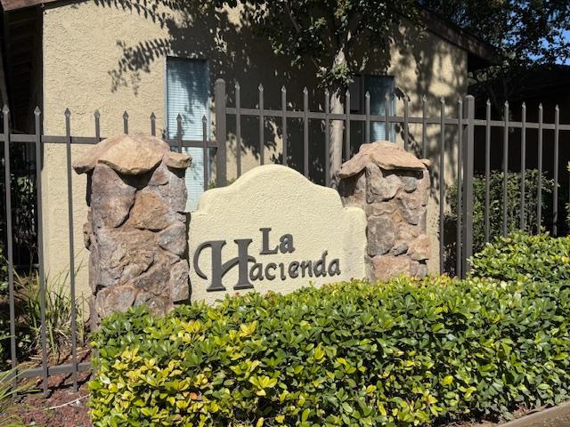 a view of a sign board with wooden fence