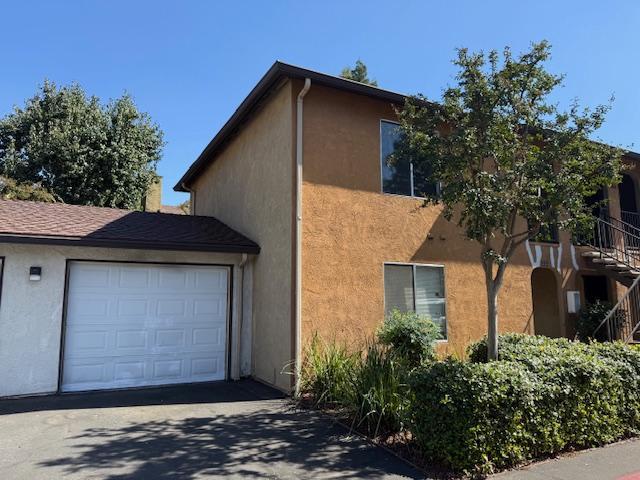 5145 East Lane Avenue, Unit 252 Fresno, CA 93727 - Photo 2 of 22 a front view of a house with a garden