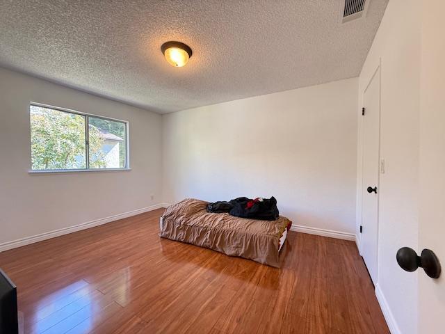 5145 East Lane Avenue, Unit 252 Fresno, CA 93727 - Photo 10 of 22 a view of bedroom with a bed and wooden floor