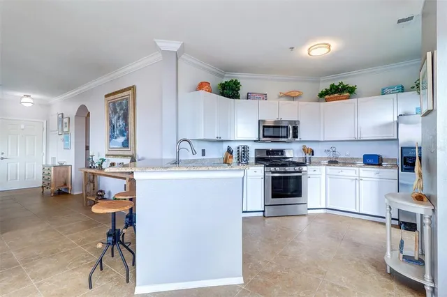 a kitchen with a refrigerator and a stove top oven