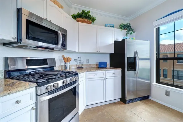 a kitchen with stainless steel appliances a stove a microwave and a refrigerator
