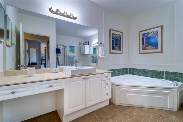a bathroom with a granite countertop sink a toilet and a bathtub