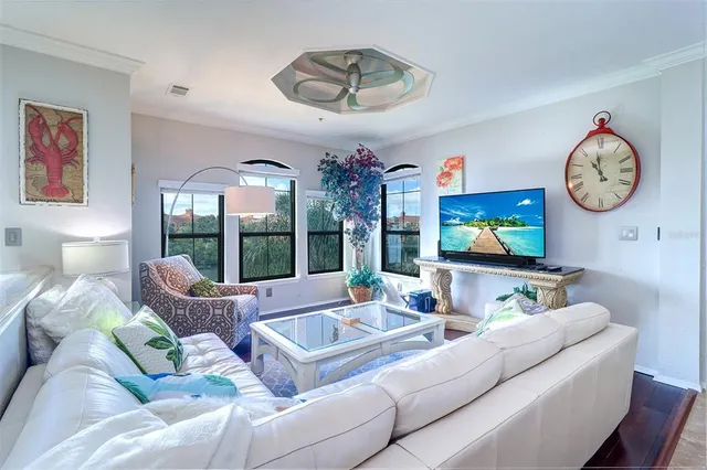 a living room with furniture a large window and a flat screen tv