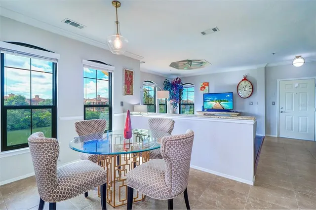 a dining room with furniture a chandelier and window