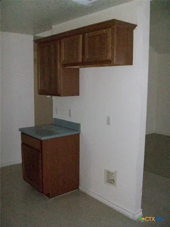 a kitchen with stainless steel appliances wooden cabinets and a stove top oven