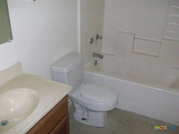 a bathroom with a sink a toilet and bathtub