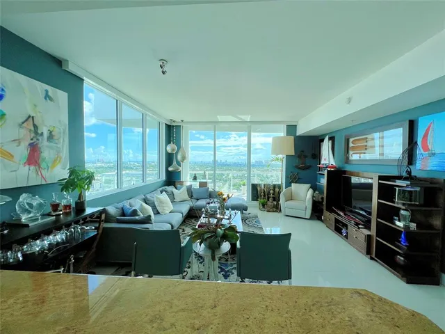 a living room with furniture gym equipment and a large window