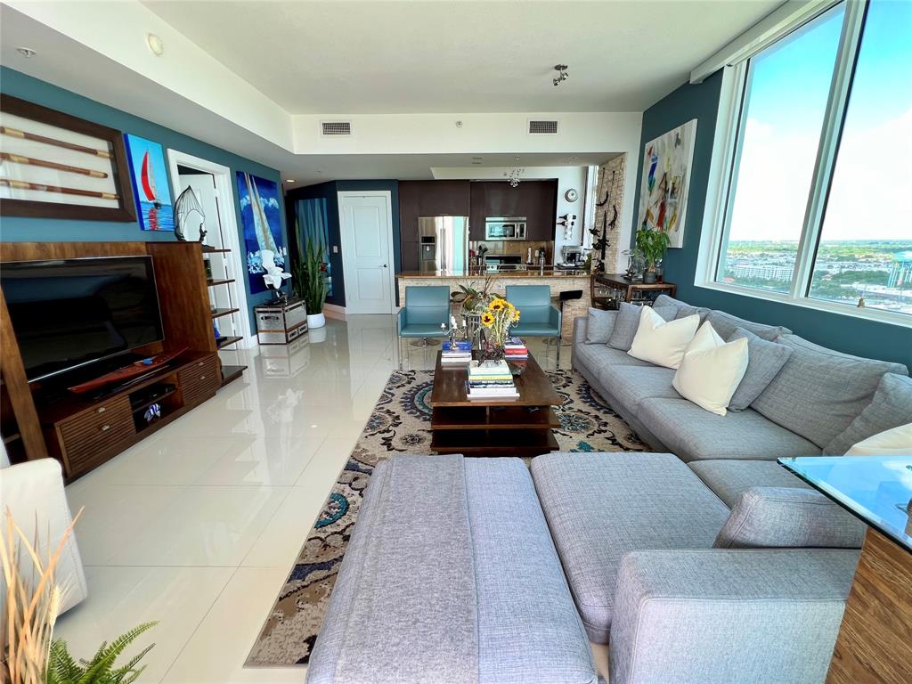 315 Northeast 3rd Avenue, Unit 2107 Fort Lauderdale, FL 33301 - Photo 11 of 19 a living room with furniture and a flat screen tv