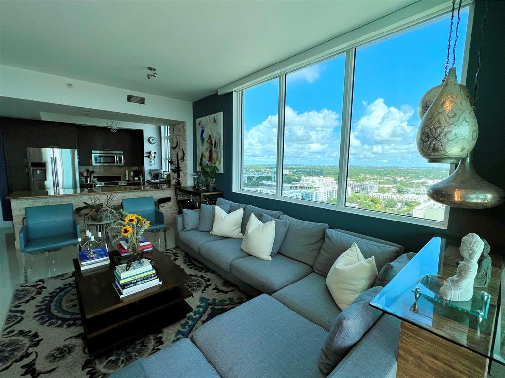 315 Northeast 3rd Avenue, Unit 2107 Fort Lauderdale, FL 33301 - Photo 12 of 19 a living room with furniture and a floor to ceiling window