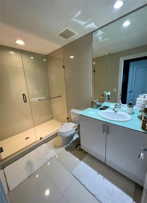 315 Northeast 3rd Avenue, Unit 2107 Fort Lauderdale, FL 33301 - Photo 14 of 19 a bathroom with a double vanity sink toilet and shower