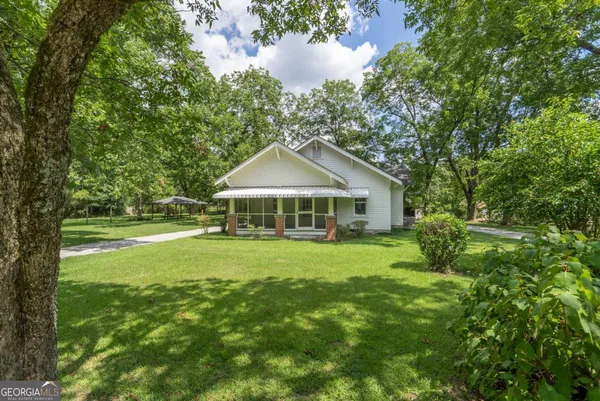 a front view of a house with garden
