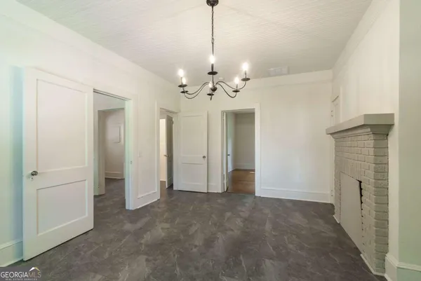 a view of a hallway with chandelier