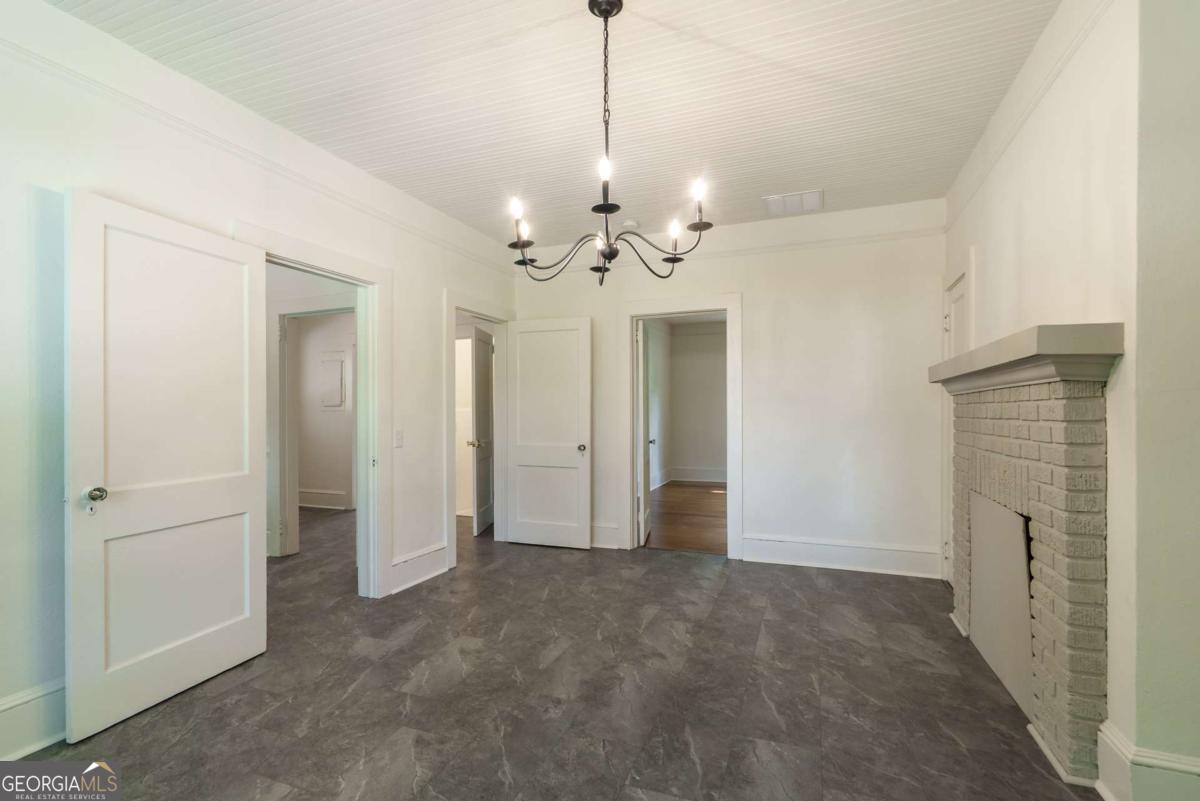 5380 Guthrie Road Loganville, GA 30052 - Photo 11 of 38 a view of a hallway with chandelier