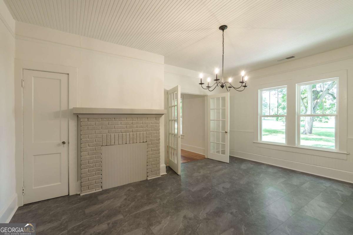 5380 Guthrie Road Loganville, GA 30052 - Photo 12 of 38 an empty room with chandelier fan and windows