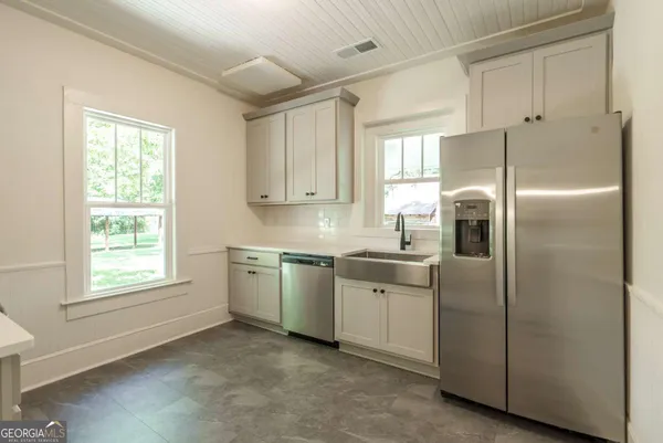 a kitchen with cabinets and stainless steel appliances