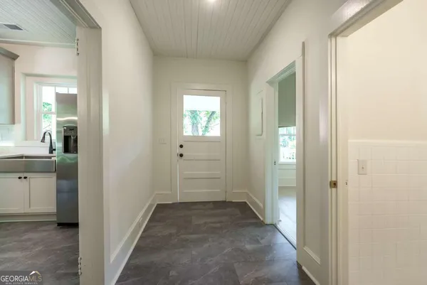 a view of a hallway with a wooden cabinets