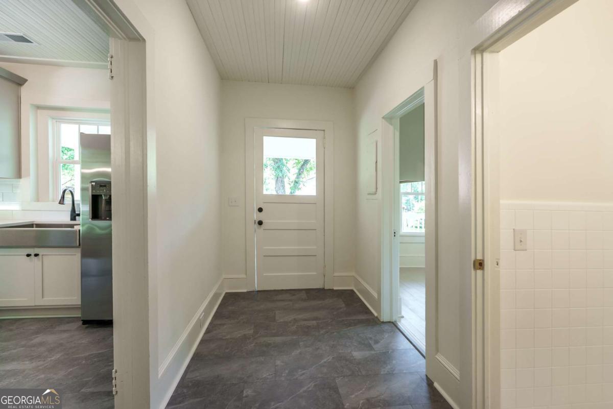 5380 Guthrie Road Loganville, GA 30052 - Photo 17 of 38 a view of a hallway with a wooden cabinets