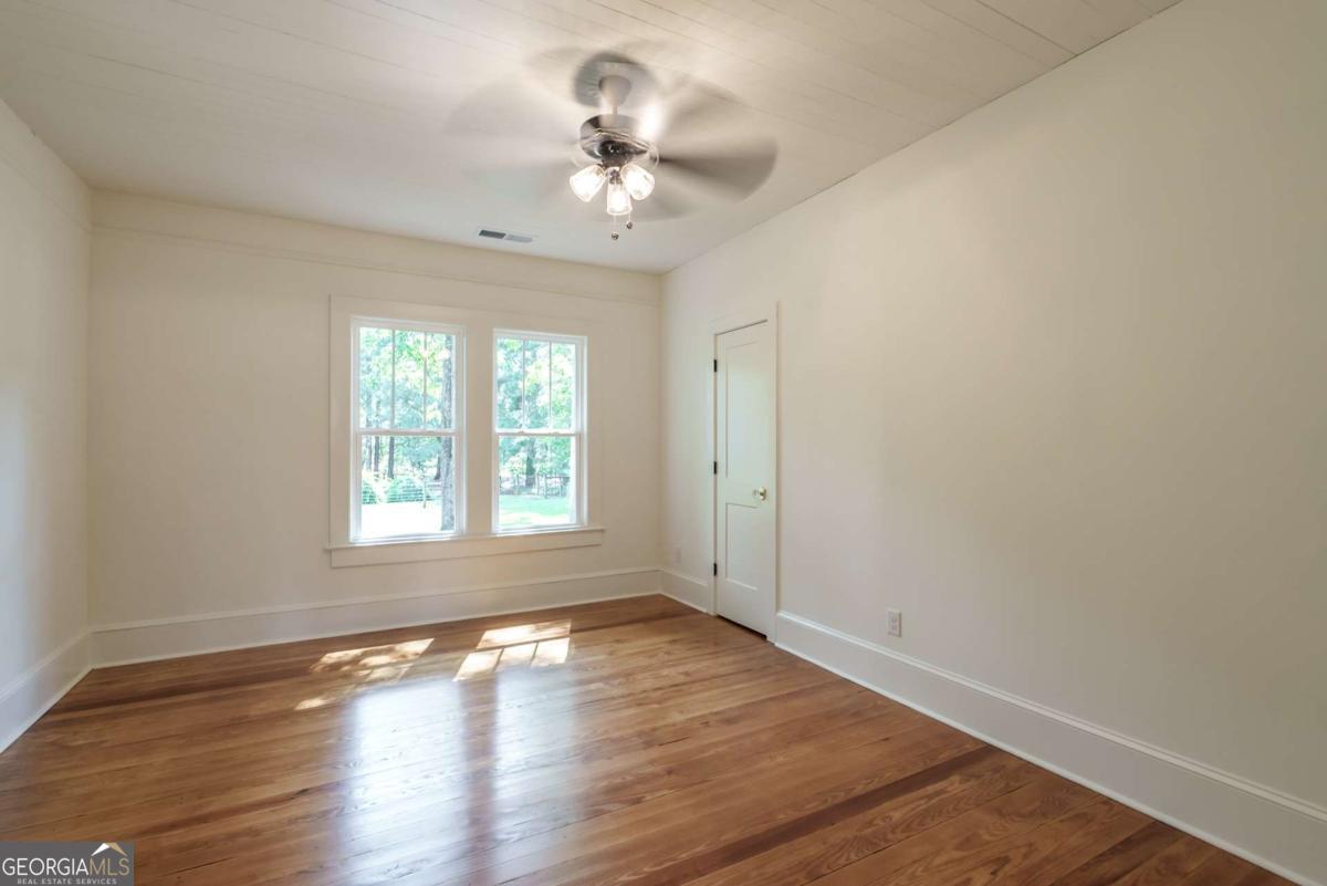 5380 Guthrie Road Loganville, GA 30052 - Photo 21 of 38 a view of an empty room with wooden floor and a window