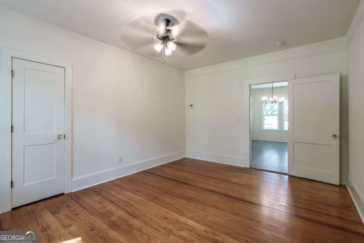 5380 Guthrie Road Loganville, GA 30052 - Photo 22 of 38 a view of an empty room with wooden floor and a window