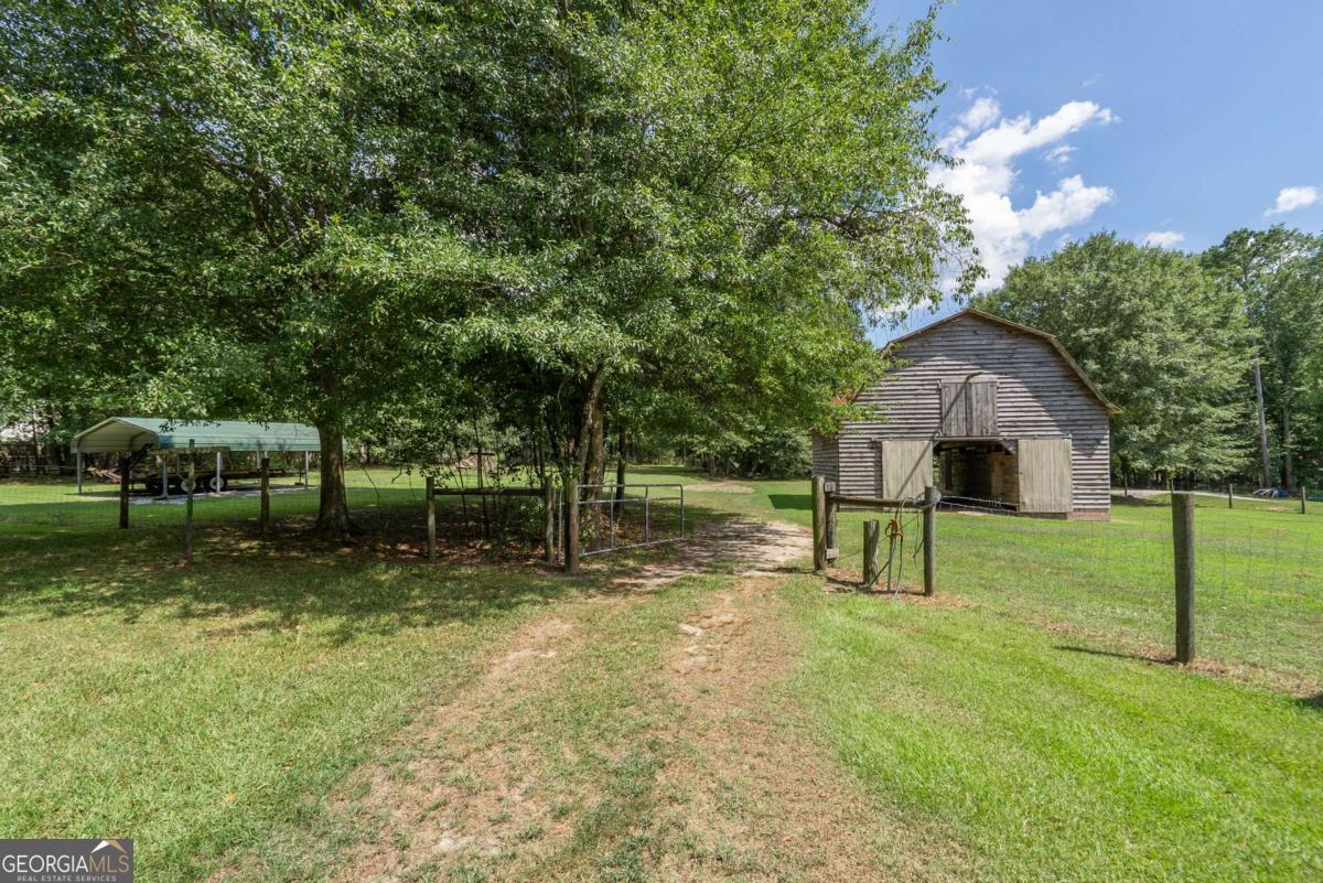 5380 Guthrie Road Loganville, GA 30052 - Photo 31 of 38 a backyard of a house with lots of green space