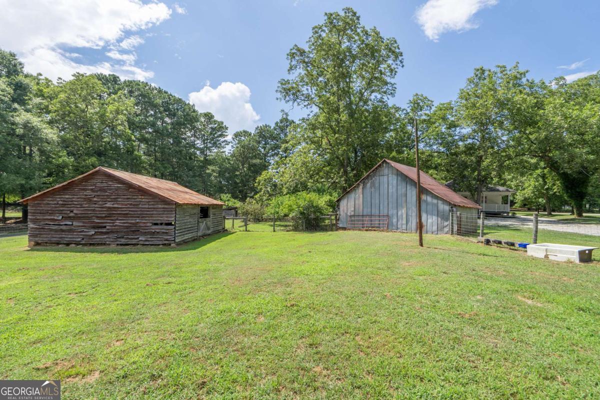 5380 Guthrie Road Loganville, GA 30052 - Photo 32 of 38 a house with trees in the background