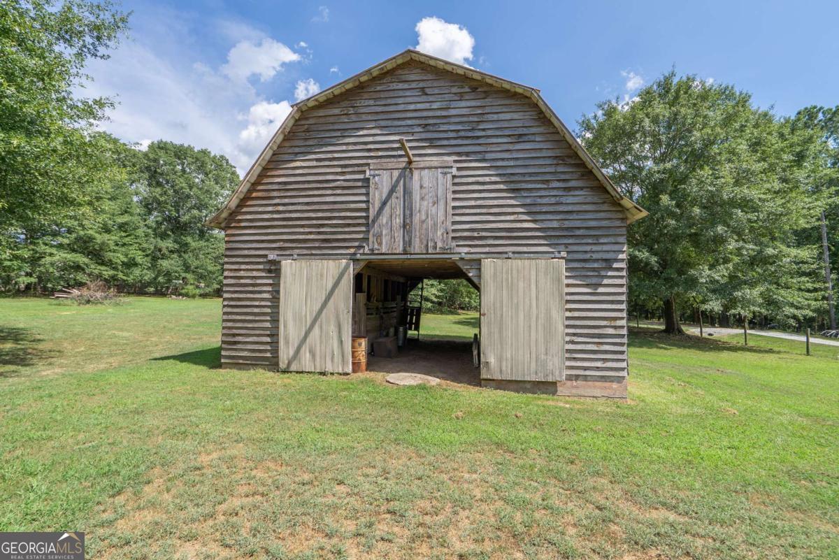 5380 Guthrie Road Loganville, GA 30052 - Photo 33 of 38 a view of a house with a yard and garage