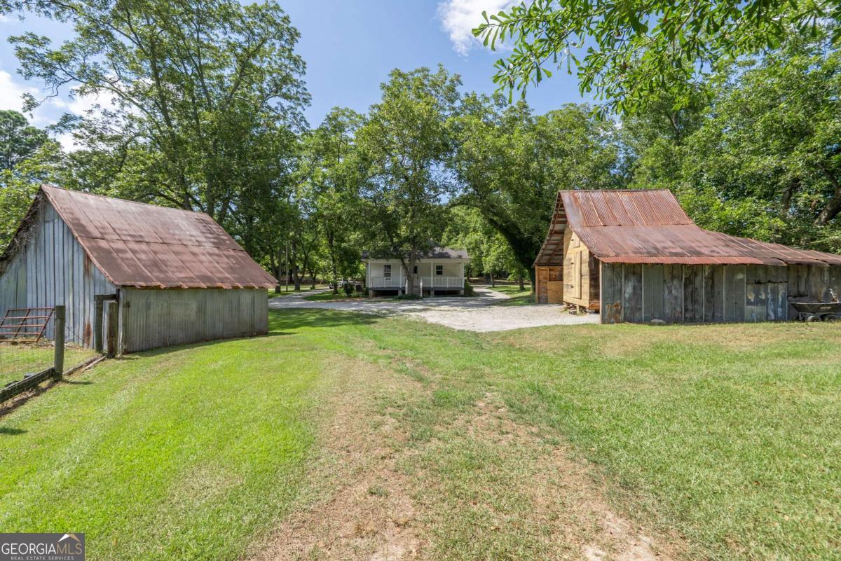 5380 Guthrie Road Loganville, GA 30052 - Photo 35 of 38 a view of a house with a yard and tree