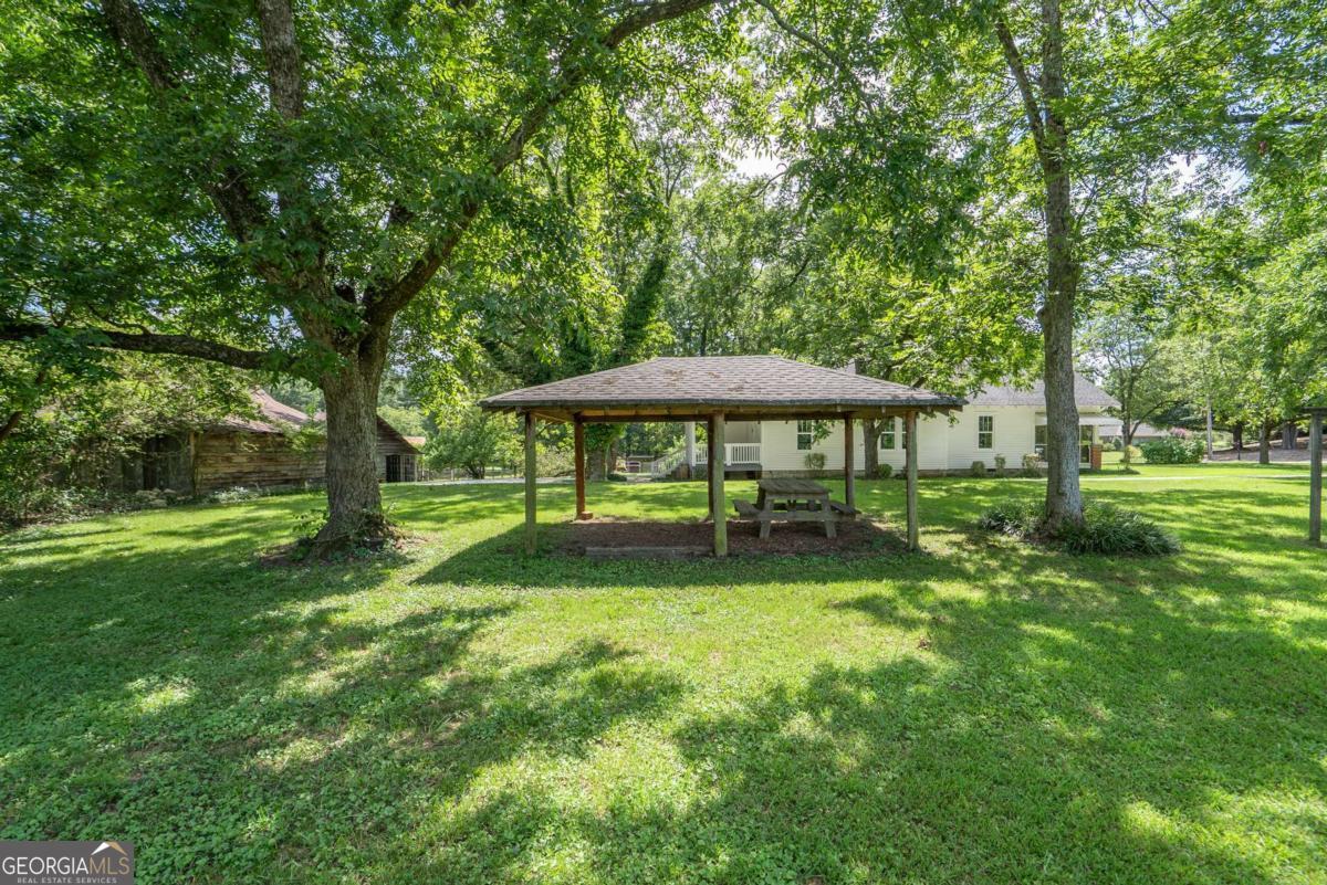 5380 Guthrie Road Loganville, GA 30052 - Photo 36 of 38 a backyard of a house with table and chairs
